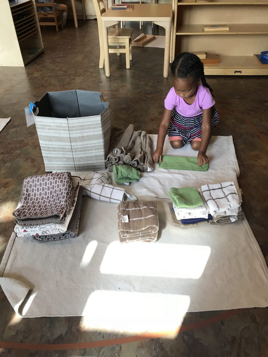 Early Childhood Practical Life Folding, The Montessori Academy of Arlington, Private School Arlington TX