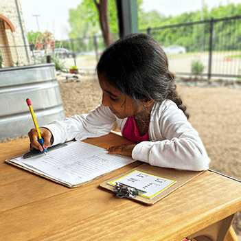 Lower Elementary working in the Outdoor Classroom